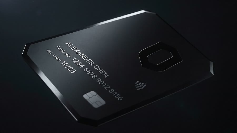 A black metal payment card catching raking light